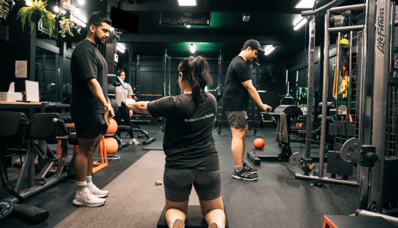 Gym members doing resistance cable training with coach at Habitat Gym in Prestons
