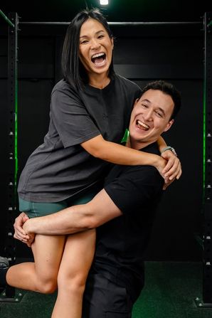 Jeannie and Ben, coaches and co-founders of Habitat Gym, sharing a happy moment inside the gym