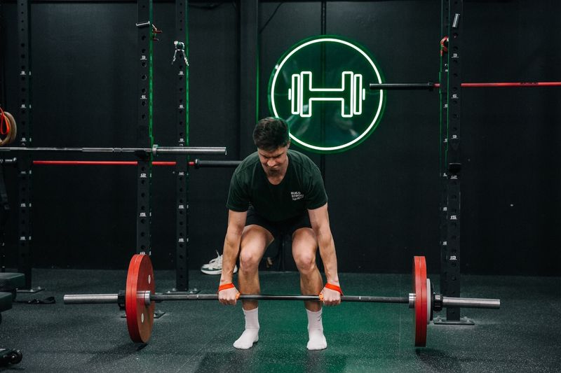 Man doing deadlifts at Habitat Gym's strength zone