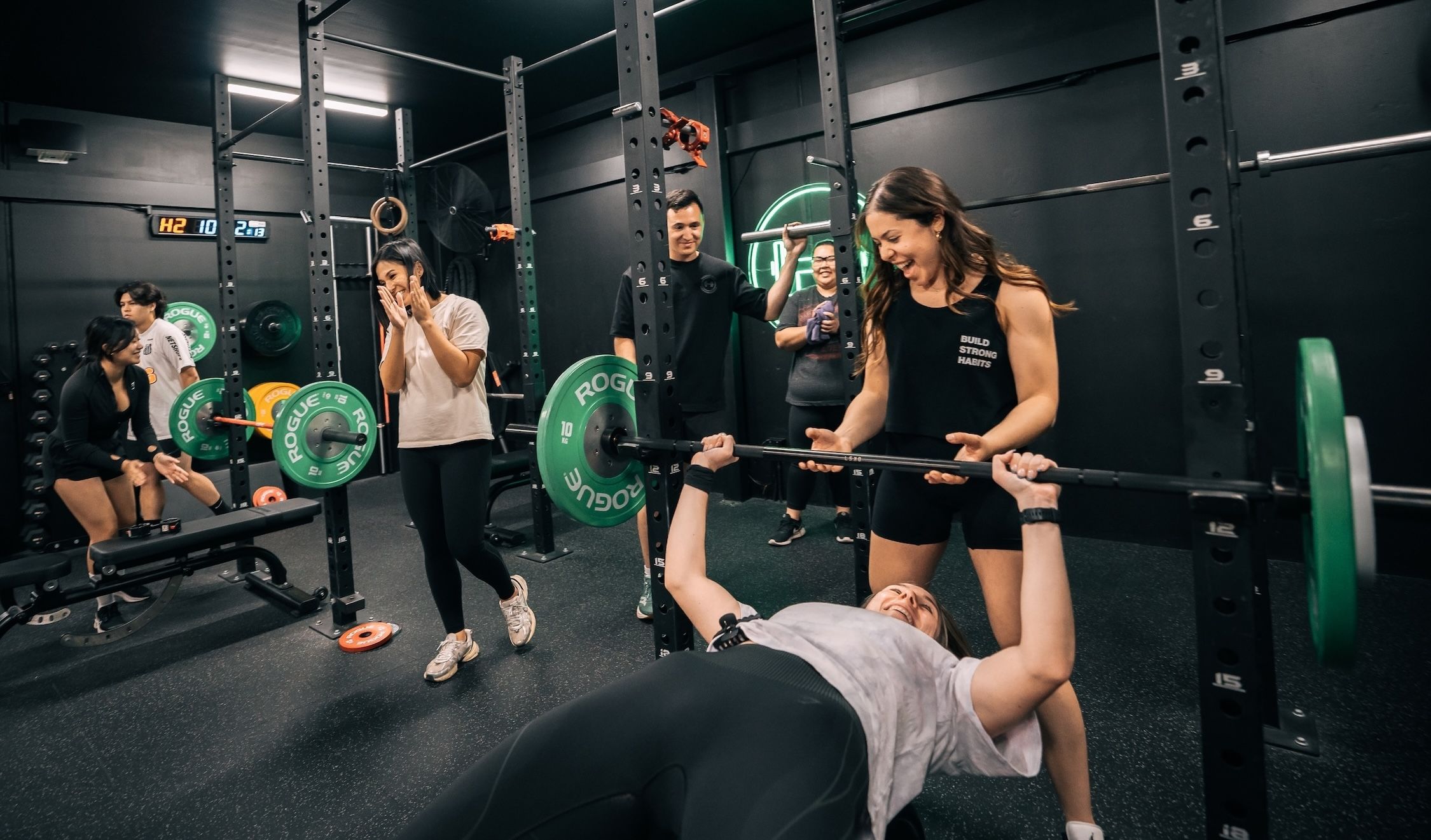 Happy Habitat coaches cheering on members during expert-led lifting workshop in Prestons gym