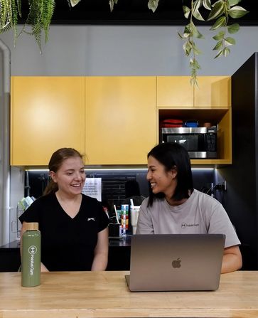 Coach and member sitting inside Habitat Gym's kitchen discussing personalised nutrition plan