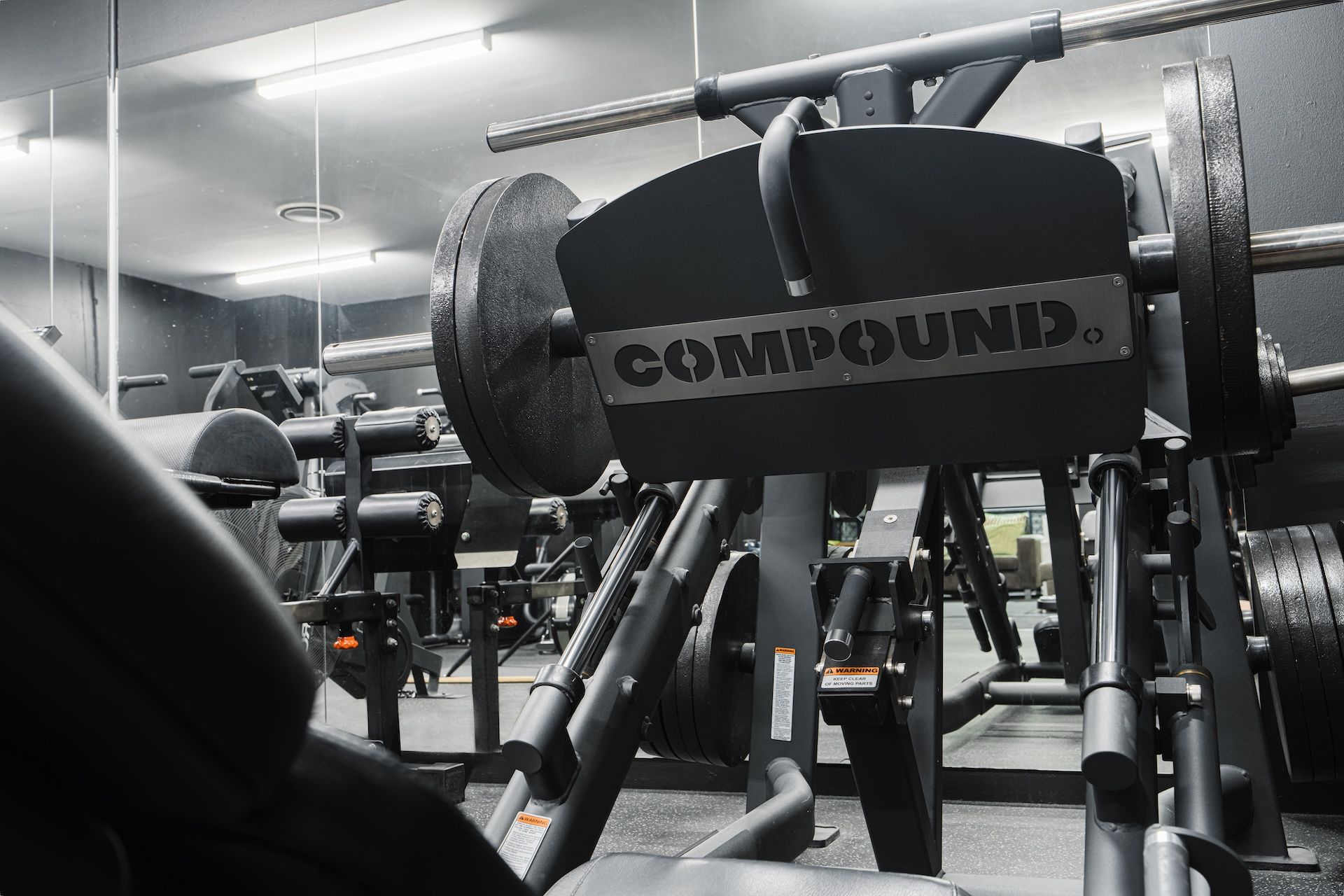 Close-up of Compound leg press machine with weight plates loaded at Habitat Gym in Western Sydney