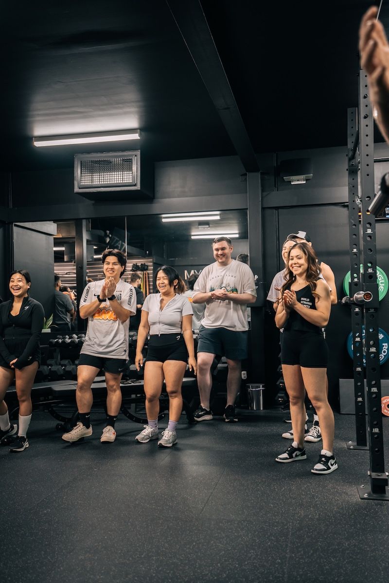 Group of members gathered for a strength training workshop at Habitat Gym in Prestons, led by a coach in a welcoming and supportive environment