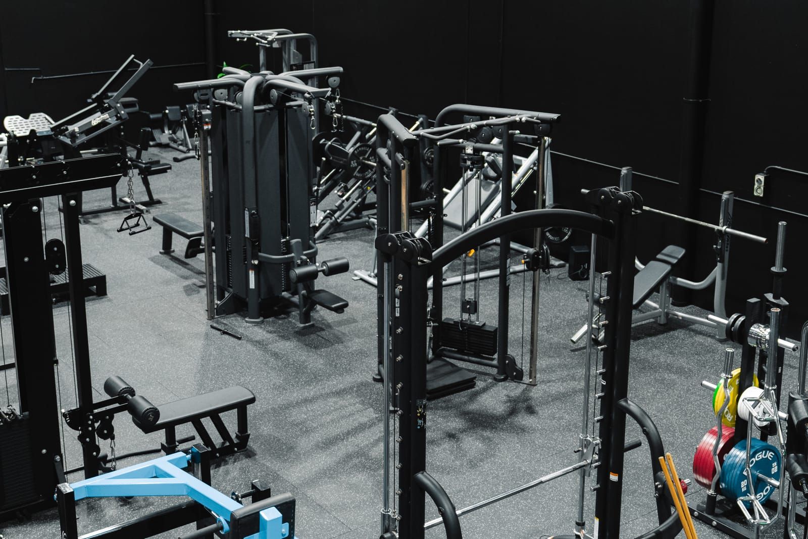 Rows of pin-loaded and cable machines across the strength floor at Habitat Gym