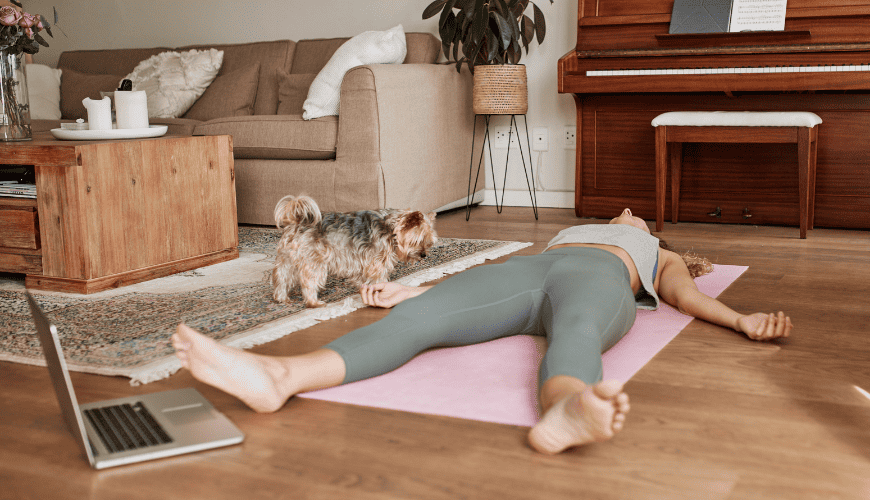 Woman resting on floor post-workout after intense strength training