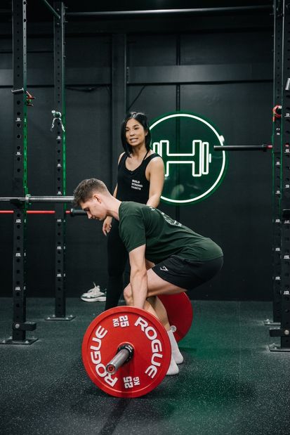 Members learning proper technique for deadlifts and squats at Prestons gym workshop