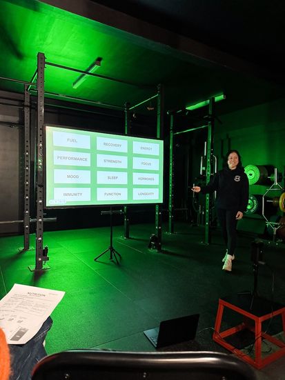Coach presenting Nutrition Workshop to members at Habitat Gym