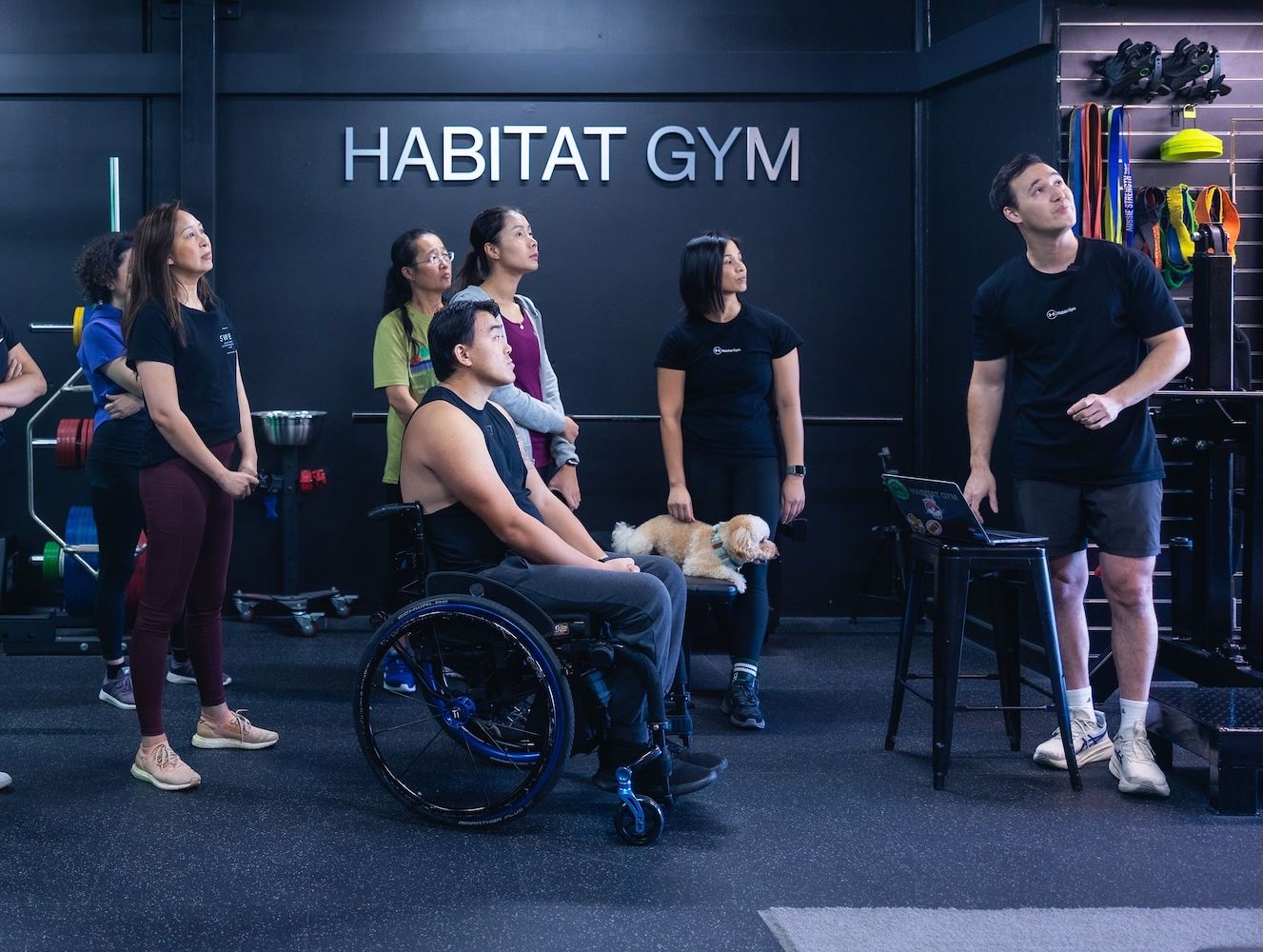 Coach teaching Program Building 101 to members at Habitat Gym in April 2025